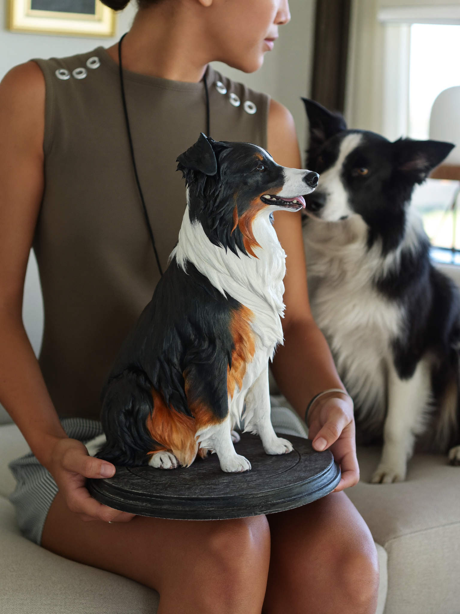 Hand-painted sculpture of a dog on a wooden base